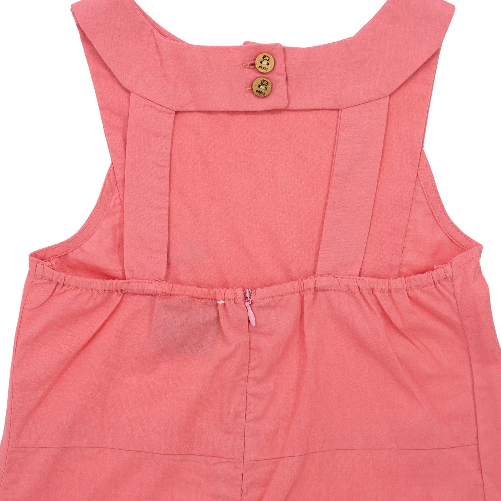 Close-up of a Karee Tea Rose Cotton Bib Neck Top for kids with button details, waist tie, and made from breathable cotton.