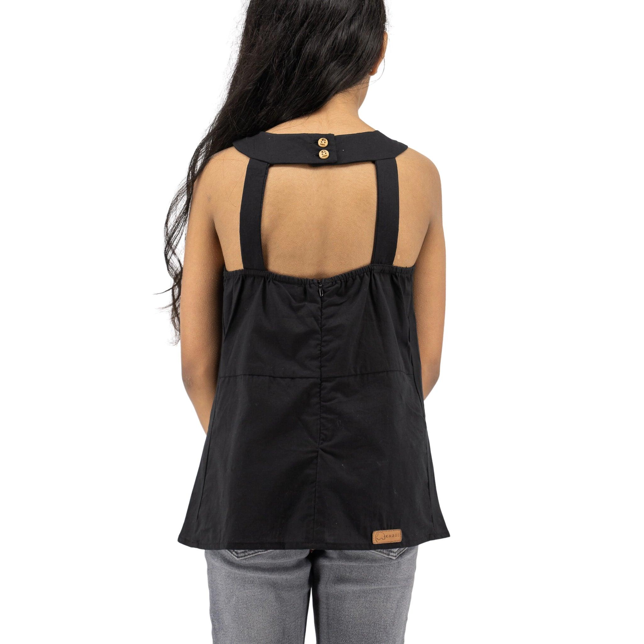 Girl from behind wearing Karee's Black Beauty Cotton Bib Neck Top for kids and jeans, standing against a white background.