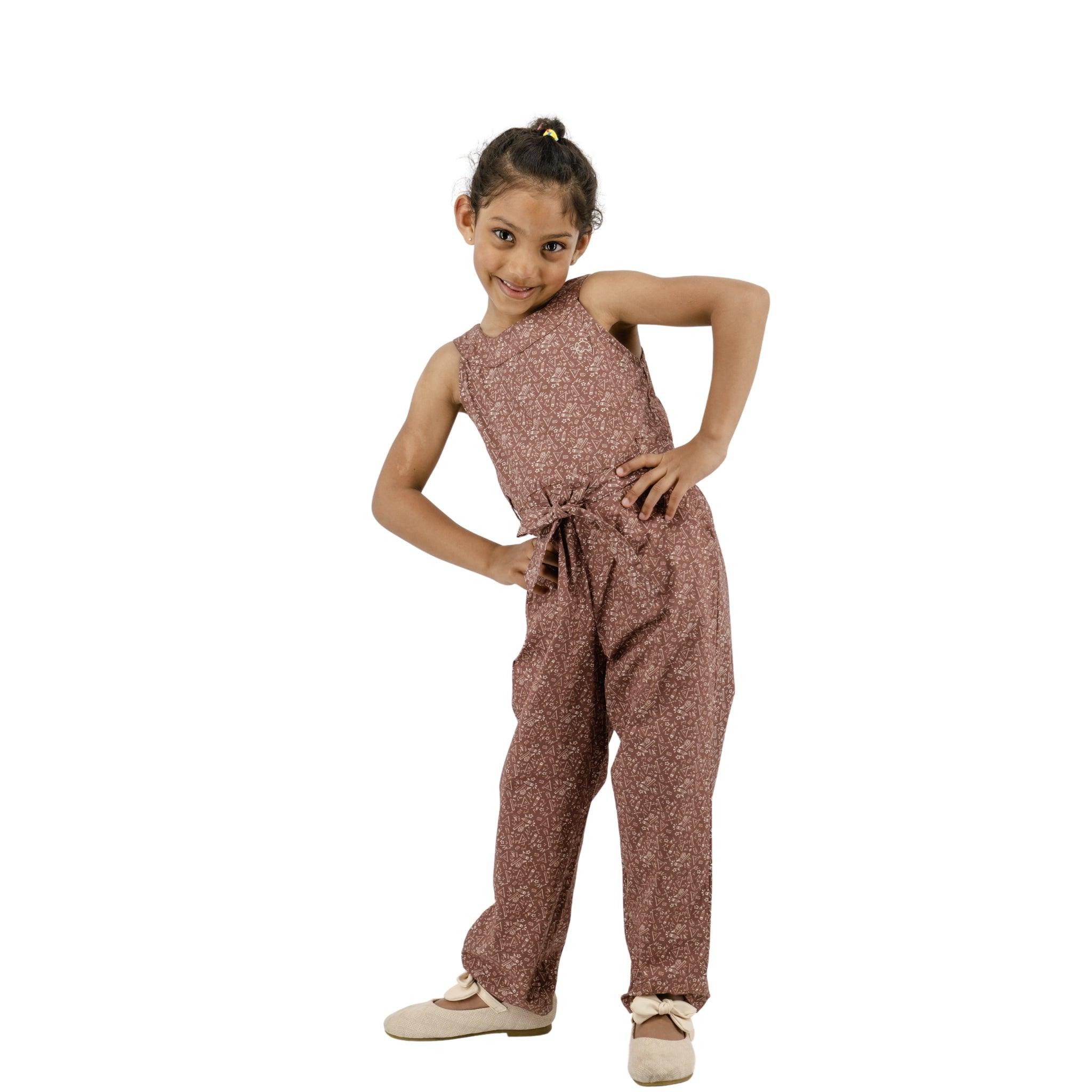 A young girl in a Karee Cocoa Brown Cotton Jumpsuit for Girls posing with her hand on her hip against a white background.