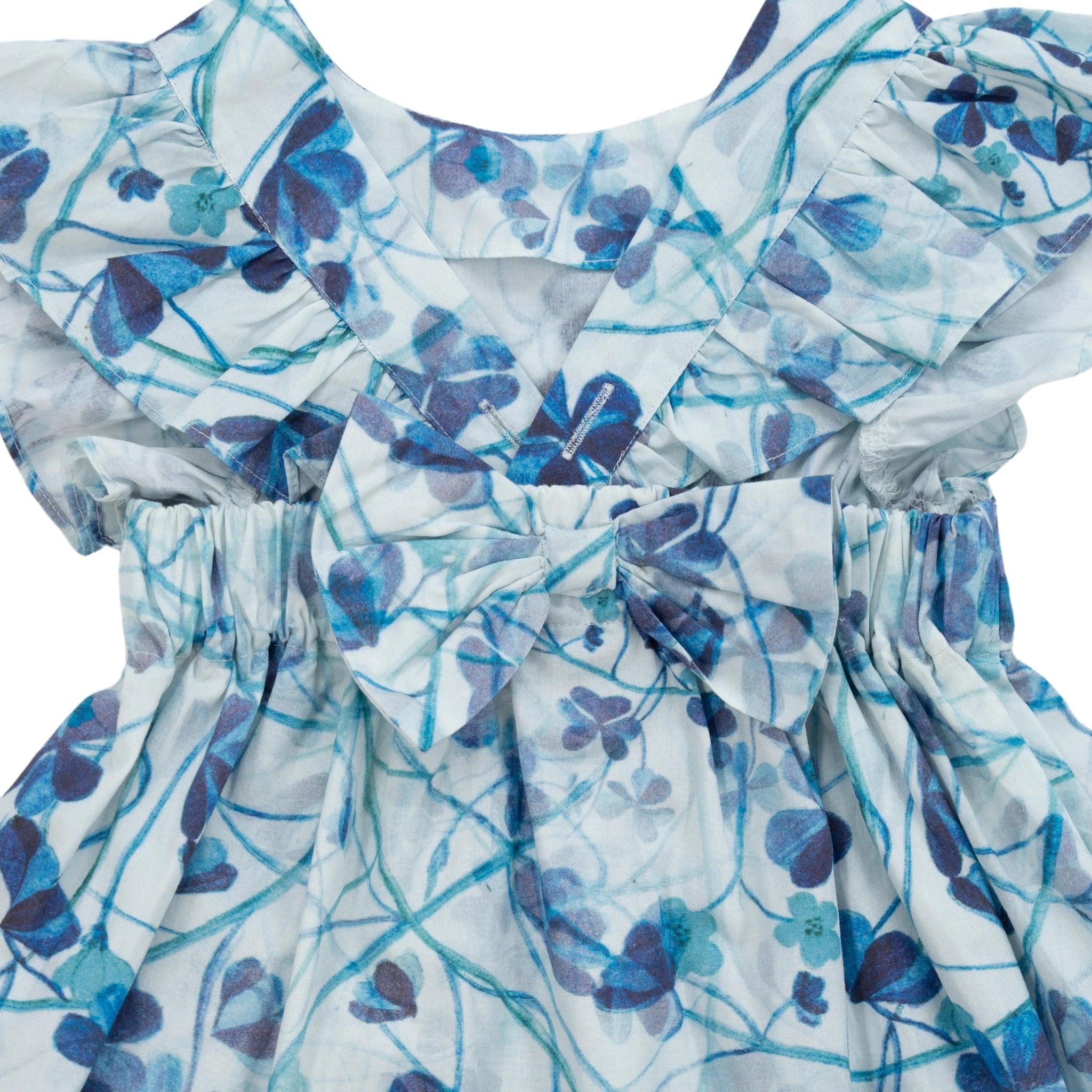 A close-up of a Karee Blue Cotton Floral Dress for Girls with blue butterfly patterns and ruffled sleeves on a white background.