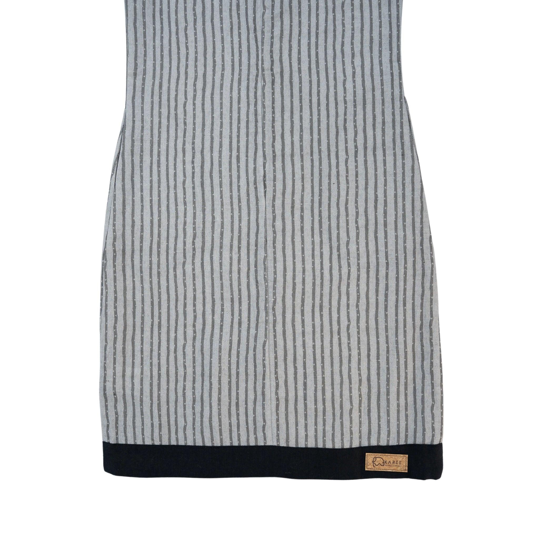 A steel grey, ribbed knit sleeveless top with a navy blue hem, featuring a small logo tag on the lower right side, displayed against a white background. 

Product Name: Linen Cotton Round Neck Frock for Kids in Steel Grey
Brand Name: Karee