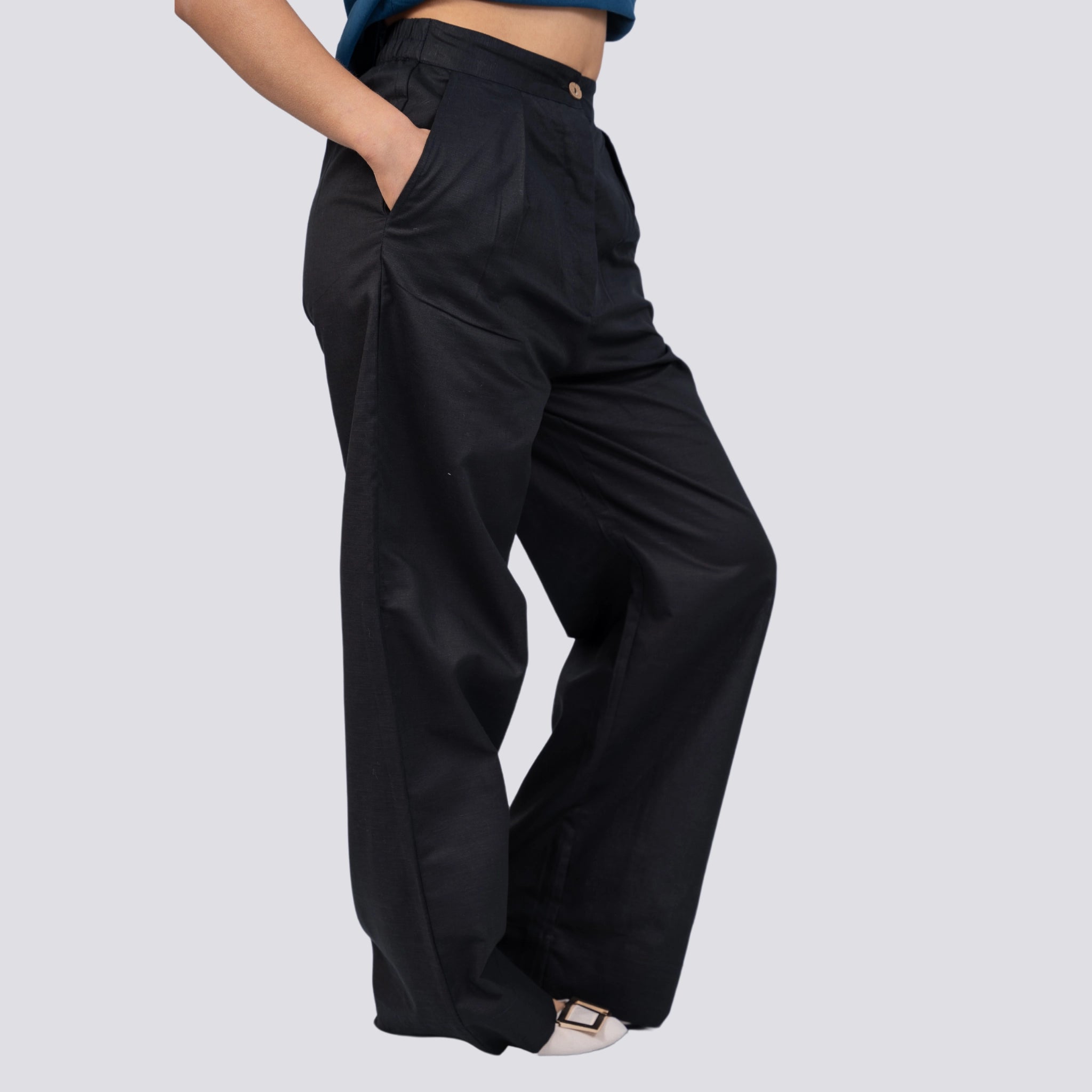 Woman wearing a Noir Wide Leg Linen Trousers from Karee