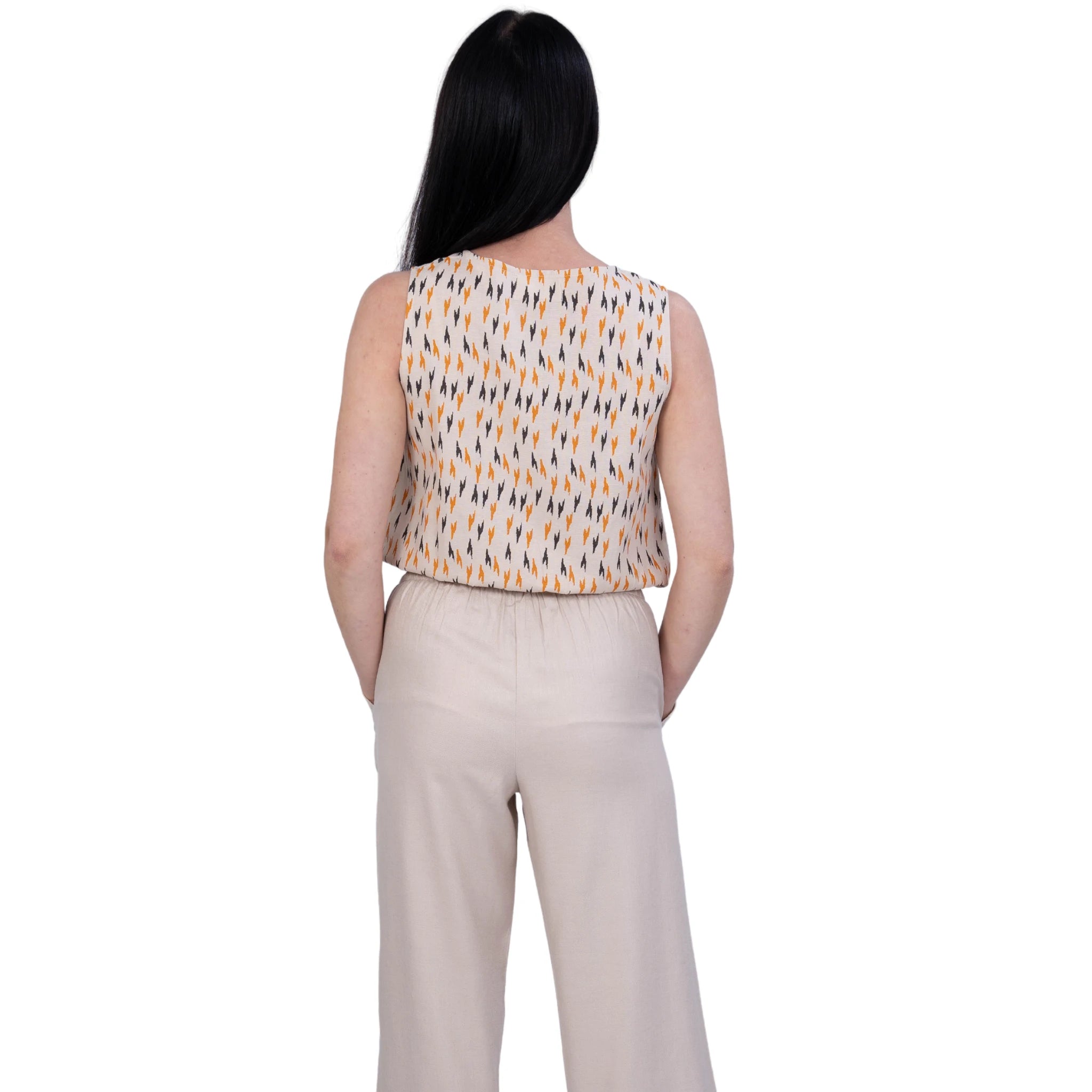 A woman turned backwards, Beige jumpsuit with print, Dual colour jumpsuit, Jumpsuit with pockets.