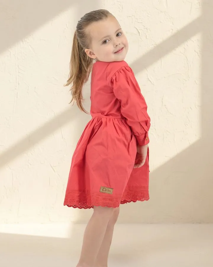 Back view of the Coral long puff-sleeve dress showing the Karee leather label on the hem