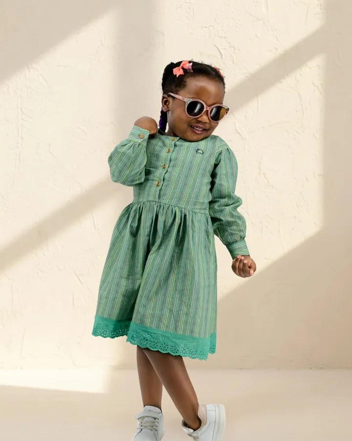 Girls' autumn dress: a girl in sunglasses dancing in the Sage stripe long puff-sleeve cotton dress